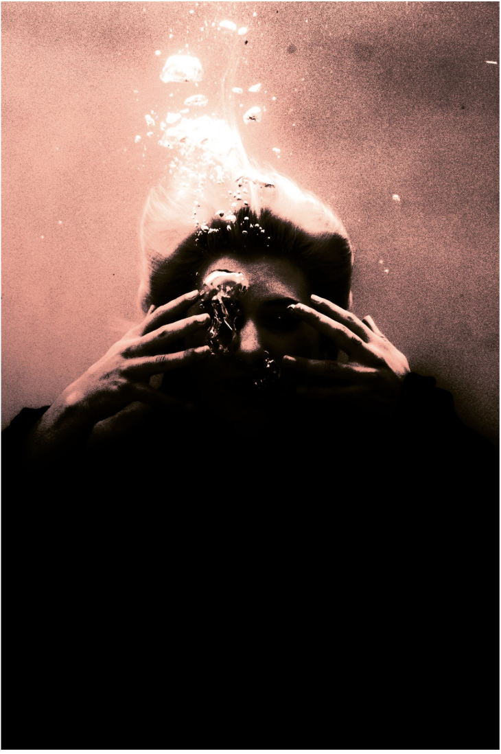 red tinted photograph of a person underwater