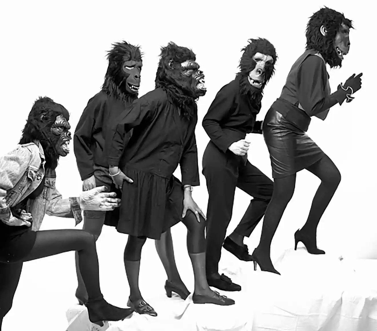 Black and white photo of a row of women wearing gorilla masks