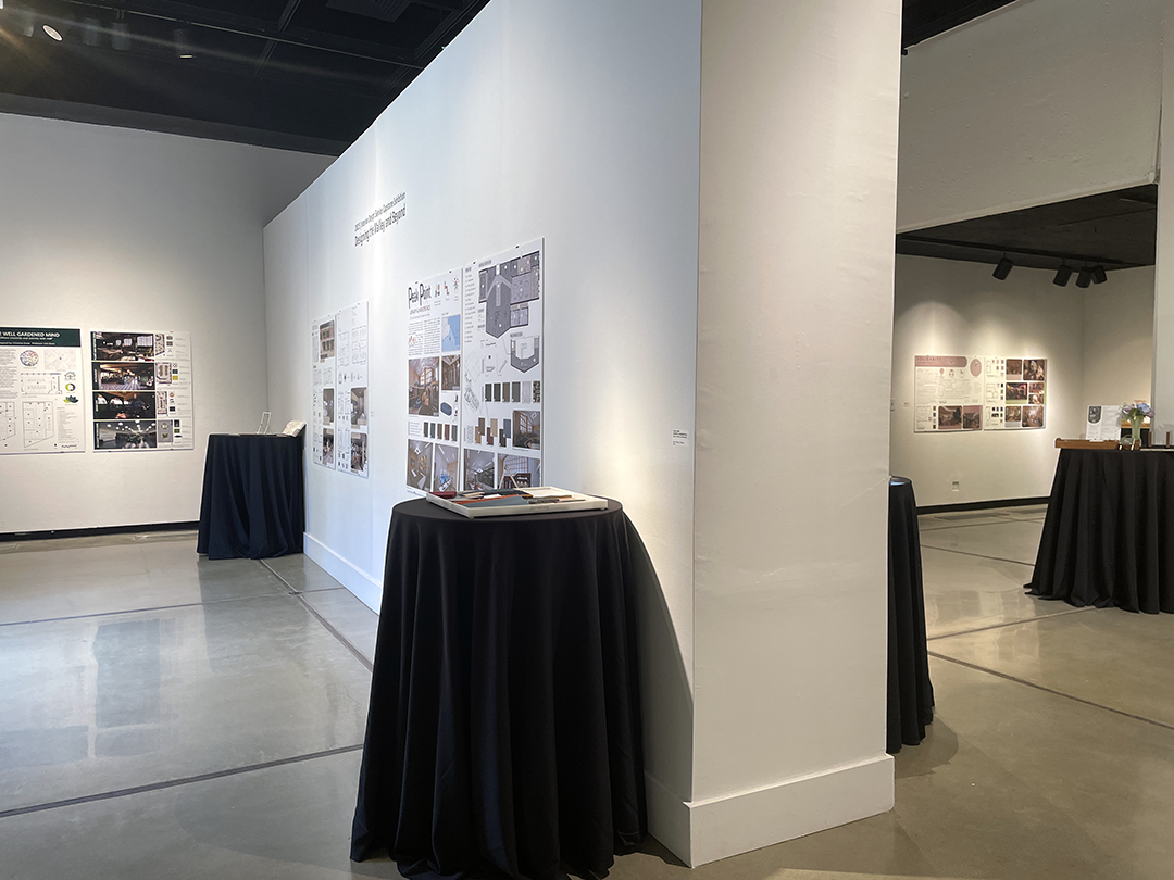 black cocktail tables with building samples in the phebe conley gallery with Interiro Design boards on the wall