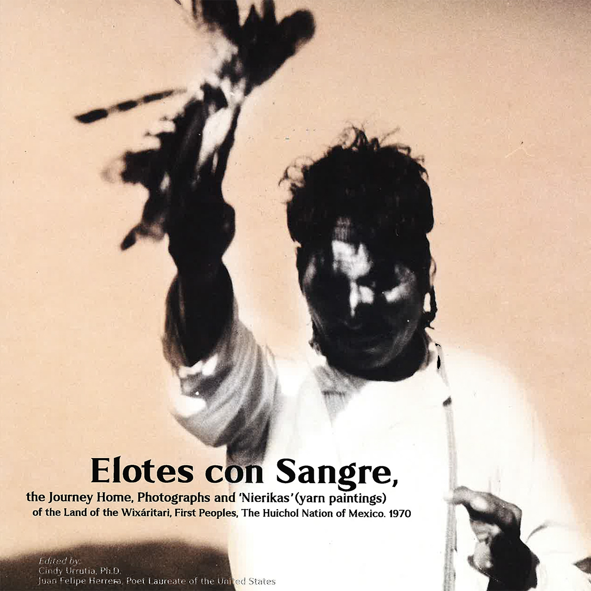 Book title in black "Elotes con Sangre, the Journey Home, Photographs and 'Nierikas' (yarn paintings) of the Land of the Wixáritari, First Peoples, The Huichol Nation of Mexico, 1970" with a sepia-tone image of a person holding a bundle over their head with one hand.