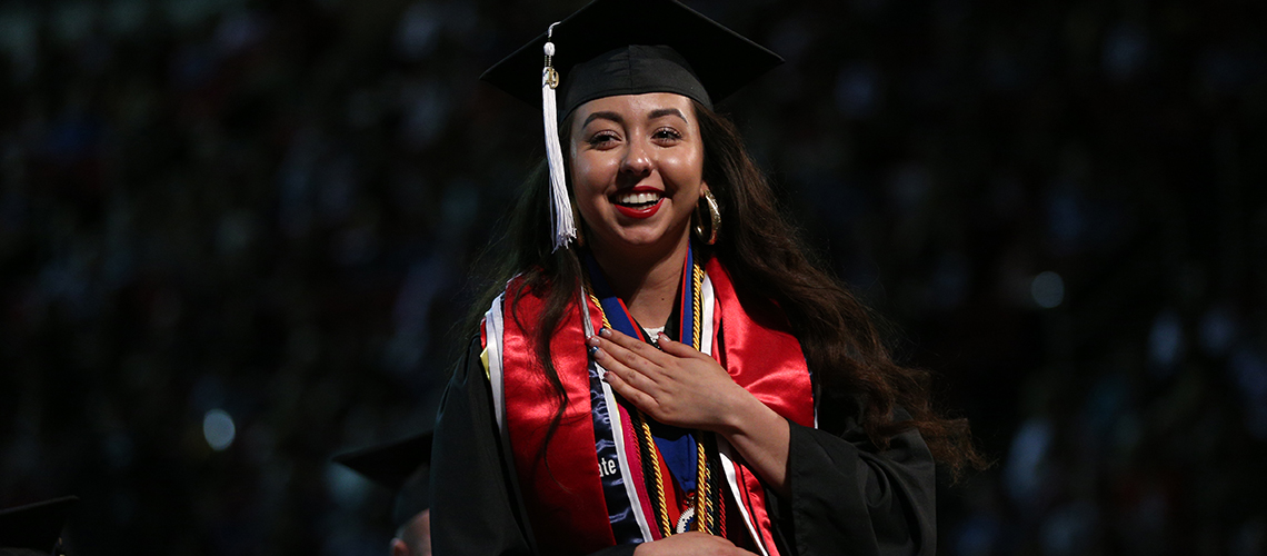 president's medalist primavera leal martinez on stage at commencement