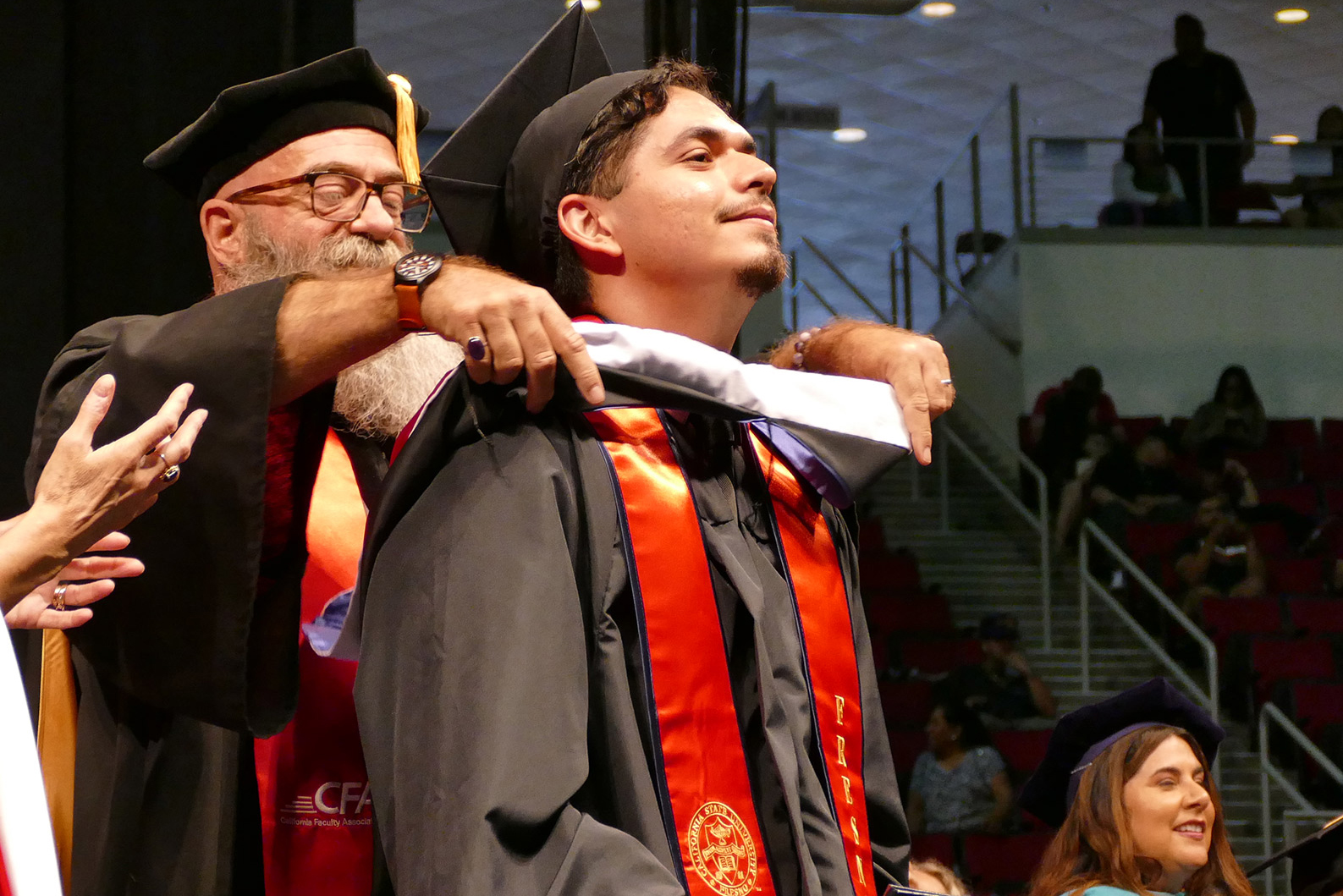 Dr. Beynon hoods M.A. graduate student Luis Granados Torres at commencement