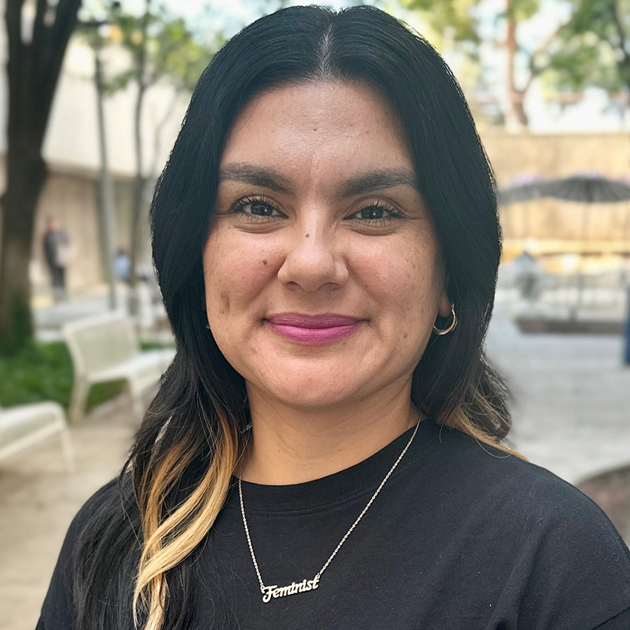 Headshot of Erica with courtyard in background.