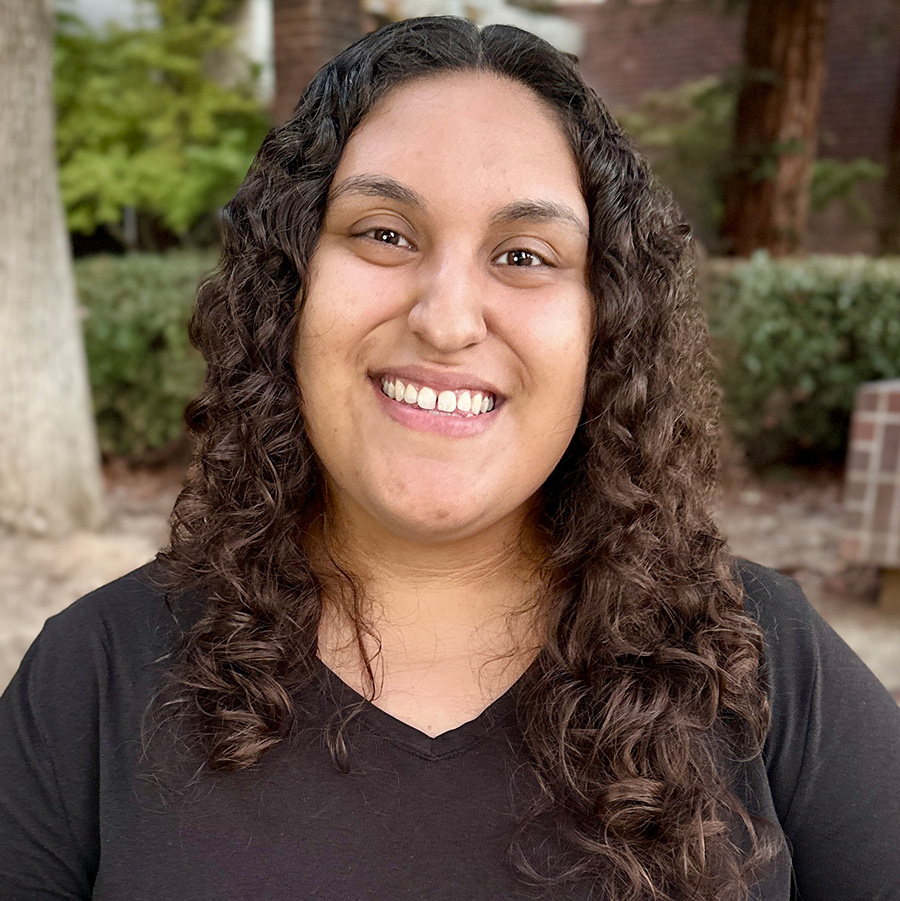 Headshot of Kayla with trees in background.