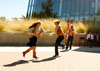 Folkloric dancers perform in from of the library at Fresno State.