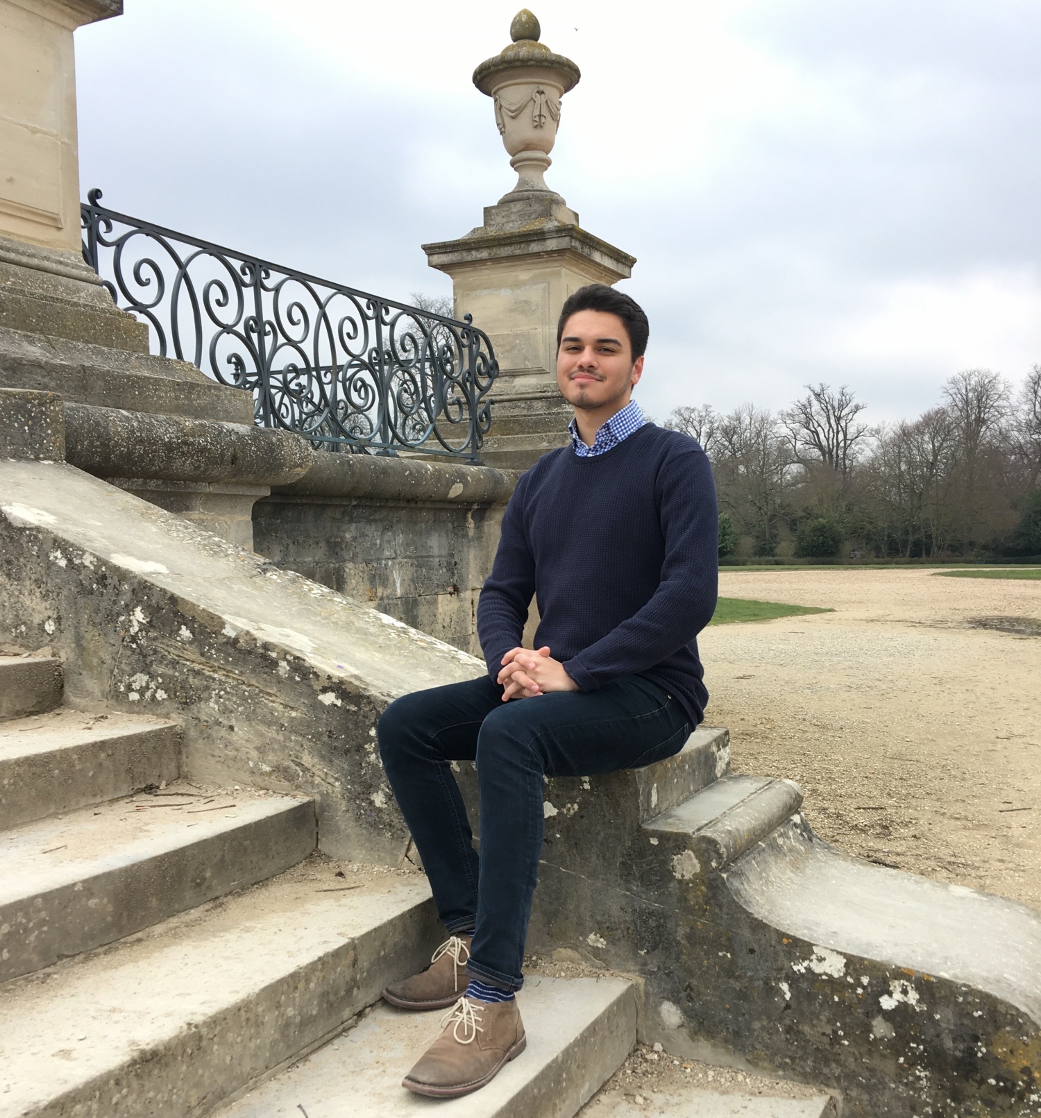 French Student sitting on an outdoor stairwell somewhere in France. 