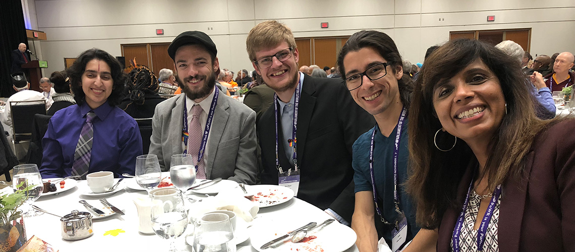 Dr. Howard sitting with students at World's Religion Parilment 