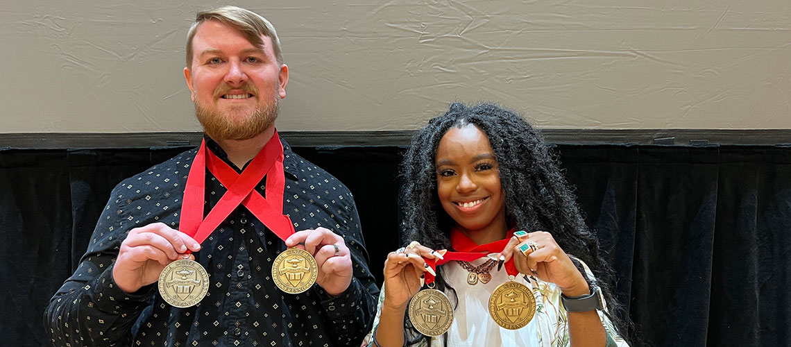Steven Hensley and Audia show off their Dean's Medals and President's Medals.